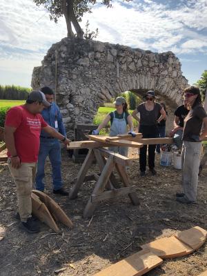 Volunteers working on one of the wooden structures that will serve to support the arch to be restored. Photo